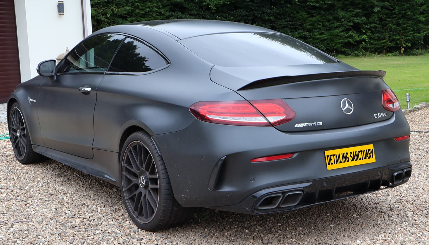 Matte black Mercedes-AMG C63 S coupe after a full detail on a gravel driveway in Wolverhampton