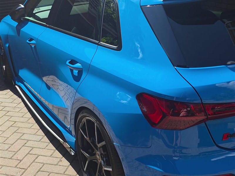 Blue Audi RS3 Sportback rear three-quarter view after a maintenance valet